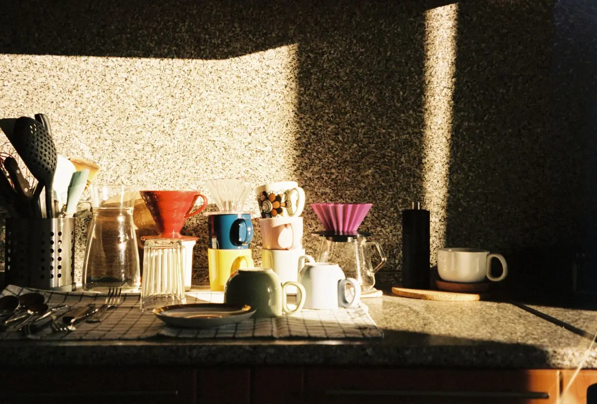 The pour-over bar in morning sun, kettles and drippers