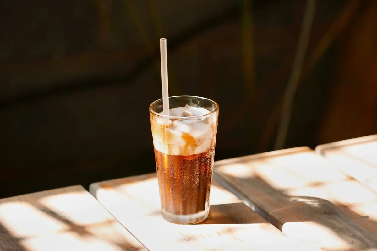 An iced cold brew on a sunlit table