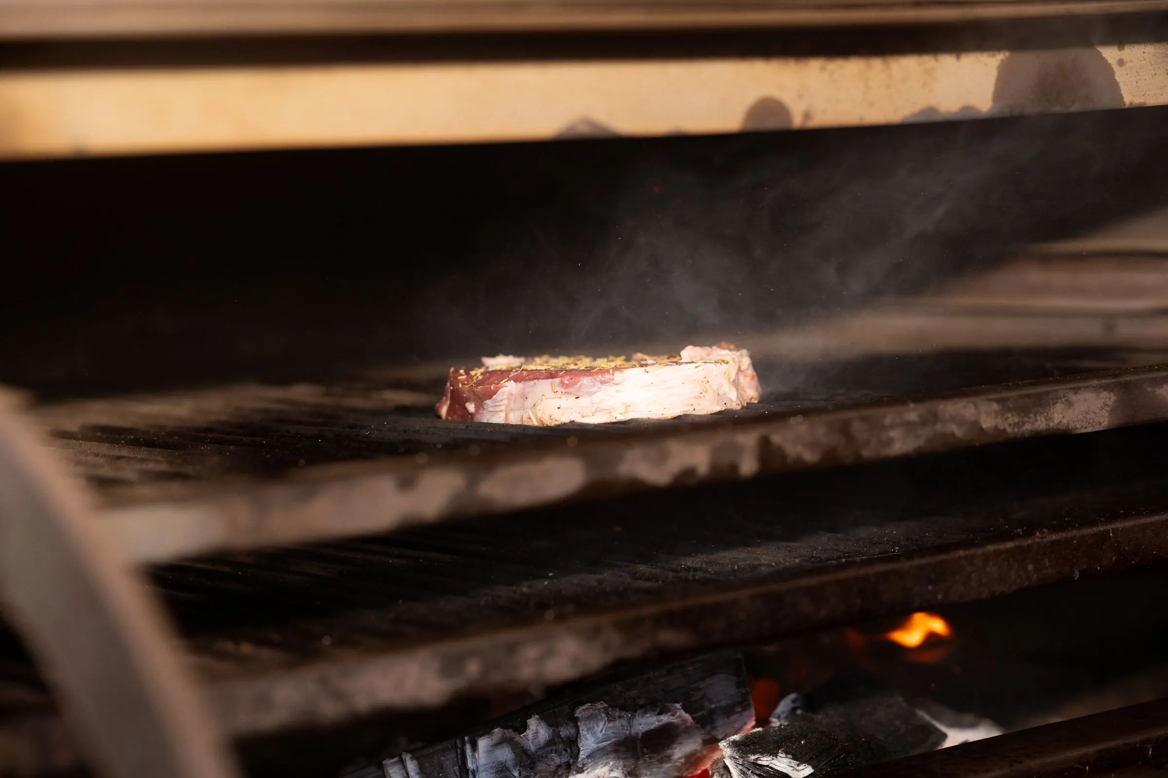 A ribeye over the coals, the fat catching