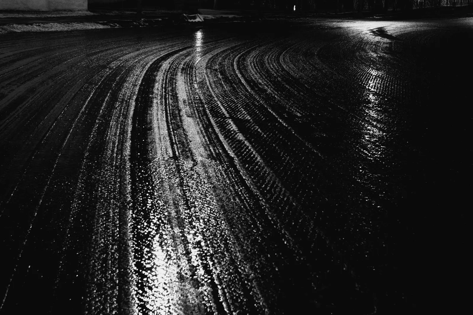Wet asphalt under a streetlight
