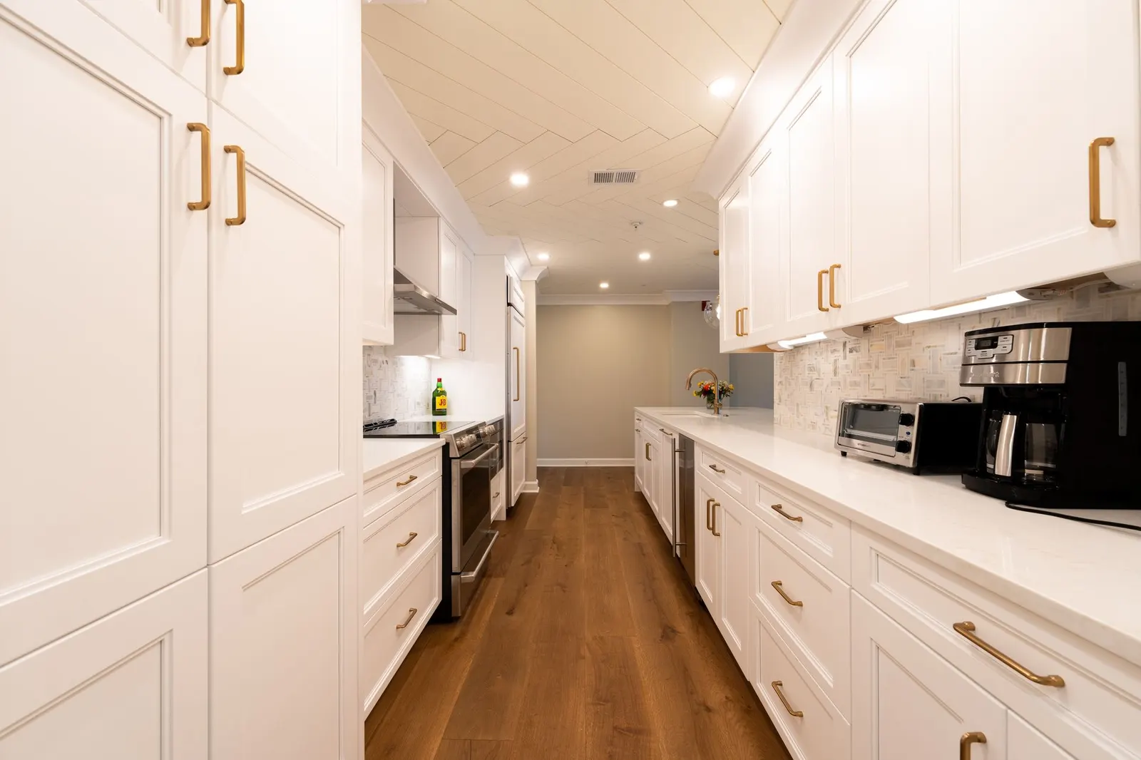 A remodelled galley kitchen, brass on white