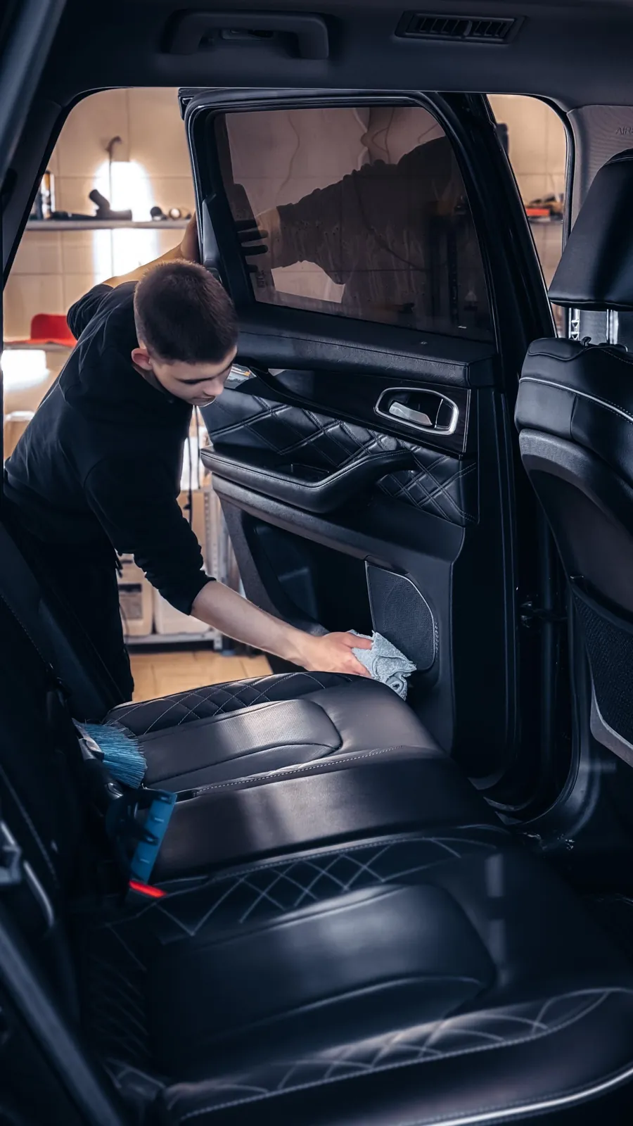 Wiping down a black leather interior
