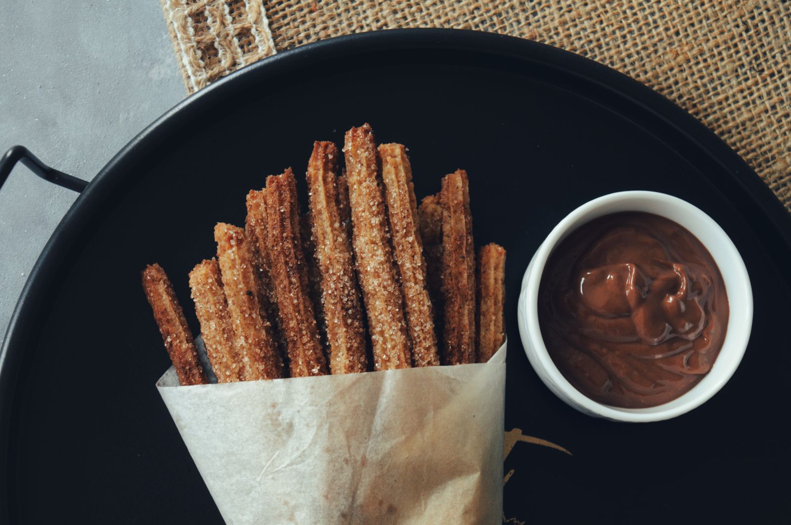 Churros in paper, with chocolate
