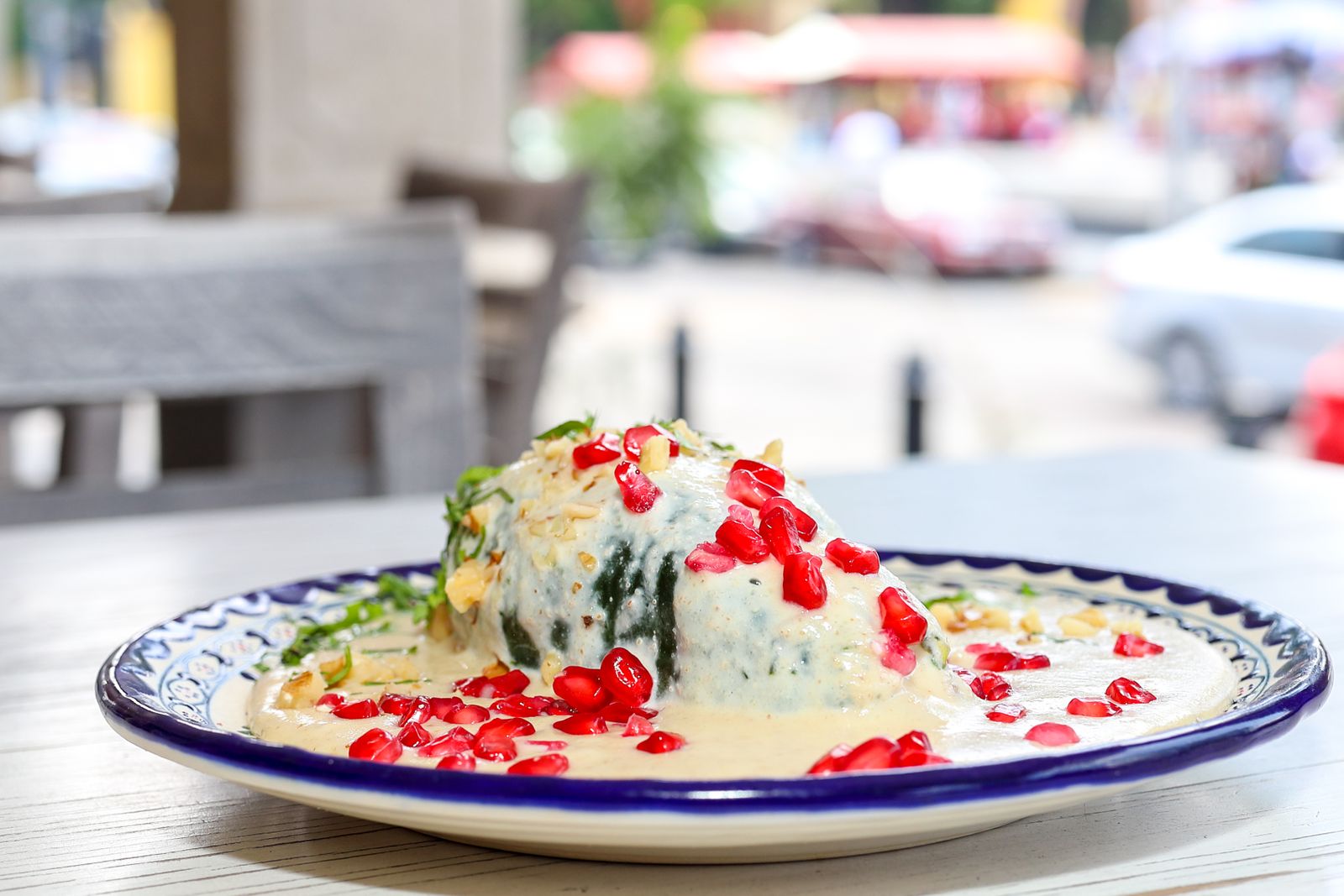 A stuffed poblano under walnut sauce and pomegranate